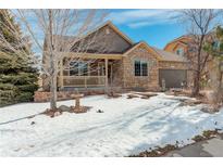 House exterior showcasing a charming curb appeal with stone accents and a well-maintained lawn at 3008 Mountain Sky Dr, Castle Rock, CO 80104