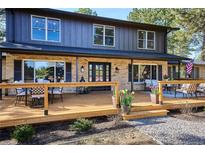 Inviting front deck with outdoor seating, perfect for enjoying the neighborhood views at 1322 Tomichi Dr, Franktown, CO 80116