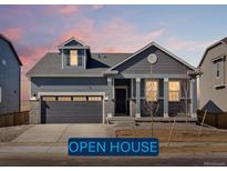 Charming single-Gathering home featuring a two-car garage and stylish architectural details at 9099 Pitkin St, Commerce City, CO 80022