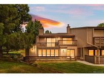 Charming condo with a spacious deck overlooking a well-manicured lawn at sunset at 7300 W Stetson Pl # 46, Littleton, CO 80123