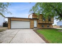Charming two-story home with a well-maintained lawn and a spacious two-car garage at 9366 Clermont Dr, Thornton, CO 80229
