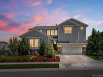 Beautiful two-story home with a well-manicured lawn, lovely landscaping, and a charming stone accents at 1291 Fountain Ln, Erie, CO 80516