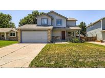 Charming two-story home with a well-maintained lawn and inviting front porch at 13265 Raritan St, Denver, CO 80234