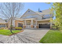 Charming two-story home with a two-car garage, stone accents, and well-maintained landscaping at 4119 Riley Dr, Longmont, CO 80503