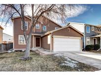 Two-story home featuring a two-car garage and a well-maintained front yard at 1130 Cardinal Ave, Brighton, CO 80601