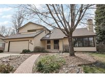Charming two-story home with a well-manicured front yard, a brick pathway, and an attached garage at 11285 Ranch Pl, Denver, CO 80234