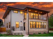 Striking two-story home featuring mixed siding, large windows, and a balcony perfect for enjoying scenic views at 2391 Hudson St, Denver, CO 80207