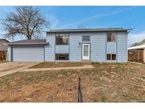 Charming two-story home features a light blue exterior, attached garage, and well-lit entrance at 15640 E Eldorado Dr, Aurora, CO 80013