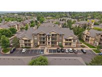 Attractive condo building with a parking lot and balconies nestled within lush landscaping and mature trees at 7413 S Quail Cir # 1435, Littleton, CO 80127