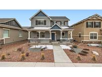 Charming two-story home with a covered front porch and landscaped front yard at 668 Sage Forest Ln, Monument, CO 80132