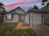 Charming single-Gathering home with a well-maintained front yard and a detached garage with a white picket fence at 4723 S Pagosa Way, Aurora, CO 80015