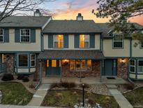 Charming townhouse with brick accents, inviting porch, and well-maintained landscaping at 7068 E Briarwood Dr, Centennial, CO 80112