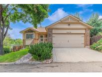 Charming single-Gathering home with a two-car garage, lush lawn, and well-maintained landscaping at 10478 W 82Nd Ave, Arvada, CO 80005