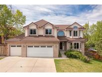 Charming two-story home with a three-car garage and a well-maintained lawn at 20816 E Shefield Pl, Parker, CO 80138