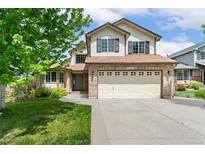 Charming two-story home with a manicured lawn, brick accents, and a spacious two car garage, located at 11335 at 11335 W 54Th Ln, Arvada, CO 80002