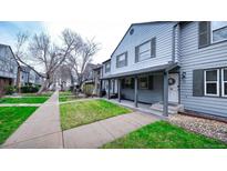 Charming townhouse with well-maintained front yard and welcoming covered porch at 677 Vrain St # 15, Denver, CO 80204