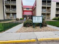 Well-maintained apartment building with visible address signage and landscaping at 14720 E Kentucky Dr # 611, Aurora, CO 80012