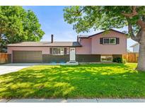 Charming two-story home with well-maintained lawn, mature trees, and inviting curb appeal at 13542 Achilles Dr, Lone Tree, CO 80124