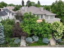 Stunning two-story home featuring lush landscaping, dual staircases, and a serene balcony at 458 Adams St, Denver, CO 80206