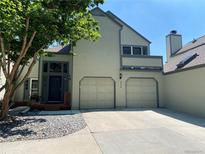 Charming two-story home featuring an attached two-car garage and a well-maintained front yard with mature trees at 5479 E Weaver Ave, Centennial, CO 80121