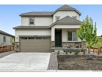 Charming two-story home featuring stone accents, a two-car garage, and a well-maintained front yard at 39713 Penn Rd, Elizabeth, CO 80107