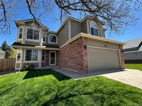 Charming two-story home featuring a well-manicured lawn and a two-car garage, perfect for suburban living at 11636 Laurel Ln, Parker, CO 80138