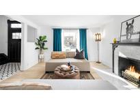 Bright living room features a cozy fireplace, large windows, and stylish decor at 2844 N Humboldt St, Denver, CO 80205