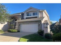 Charming two-story home with stone accents, attached two car garage, and well manicured lawn at 588 Stafford Cir, Castle Rock, CO 80104