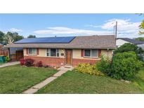 Charming single-story home featuring solar panels, well-maintained lawn, and inviting curb appeal at 41 S Fenton St, Lakewood, CO 80226