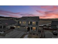 Two-story home with attached garage, visible from above at dusk at 1210 Horsetail Loop, Elizabeth, CO 80107