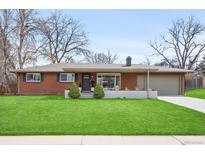 Charming red brick ranch-style home with a manicured lawn and attached garage at 3560 S Glencoe St, Denver, CO 80237