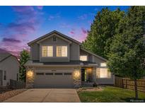 Charming two-story home with a well-maintained lawn and a two car garage at 6230 Snowberry Ave, Firestone, CO 80504