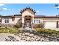 Inviting single story home with manicured lawn, stone accents, and a charming front entrance at 1254 S Balsam Ct, Denver, CO 80232