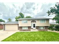 Charming two-story home with a manicured front yard and attached garage at 845 S 9Th Ave, Brighton, CO 80601