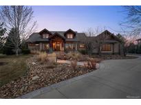 Charming home exterior featuring professional landscaping, a stone driveway and beautiful lighting at 8912 Little Raven Trl, Niwot, CO 80503