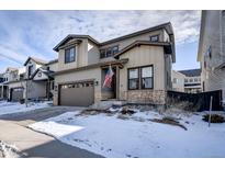 Two-story home with attached garage and landscaped front yard at 11220 Bellsong Ln, Littleton, CO 80125