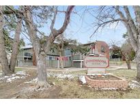 A charming view of the Ponderosa Ridge complex surrounded by trees and a well-maintained yard at 857 S Van Gordon Ct # I207, Lakewood, CO 80228