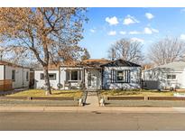 Charming single-story home with a welcoming front porch and well-maintained landscaping at 4389 S Sherman St, Englewood, CO 80113