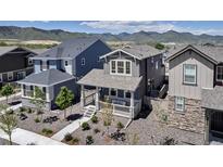 Charming two-story home showcasing a quaint front porch and professionally landscaped yard at 8049 Monte Vista Cir, Littleton, CO 80125