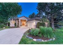 Charming home with stone accents, manicured landscaping, and inviting front porch and bench at 3201 Country Club Pkwy, Castle Rock, CO 80108