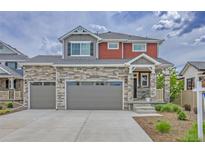 Inviting two-story home with stone accents, three-car garage, and well-maintained landscaping at 21900 E 46Th Pl, Aurora, CO 80019