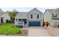 Charming two-story home with a well-manicured front yard and a cozy porch at 7767 Elmwood St, Littleton, CO 80125