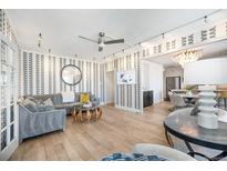 Bright living room with patterned wallpaper, modern track lighting, and hardwood floors at 99 S Downing St # 605, Denver, CO 80209
