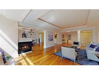 Spacious living room featuring a fireplace and gleaming hardwood floors, perfect for entertaining at 1891 Curtis St # 1613, Denver, CO 80202