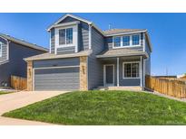 Inviting two-story home featuring a gray exterior, attached garage, and well-manicured front lawn at 5663 W 118Th Pl, Westminster, CO 80020
