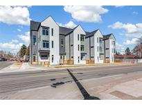 Modern townhome complex with gray and white exteriors and contemporary design elements at 5375 W 14Th Ave, Lakewood, CO 80214