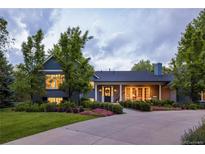 Charming two-story home with a well-manicured lawn and mature trees, bathed in the soft glow of twilight at 15 South Ln, Cherry Hills Village, CO 80113