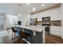 Modern kitchen with stainless steel appliances and island at 15476 W 64Th Loop # C, Arvada, CO 80007