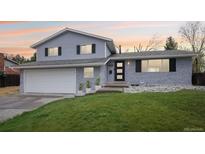 Charming two-story home with a well-maintained lawn and an attached two-car garage at 9435 Osceola St, Westminster, CO 80031
