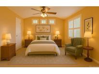 A cozy bedroom featuring a ceiling fan, three windows above the headboard and tasteful decor at 2608 S Troy Ct, Aurora, CO 80014
